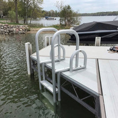 Dock with a ladder leading into the water, surrounded by trees and a boat.